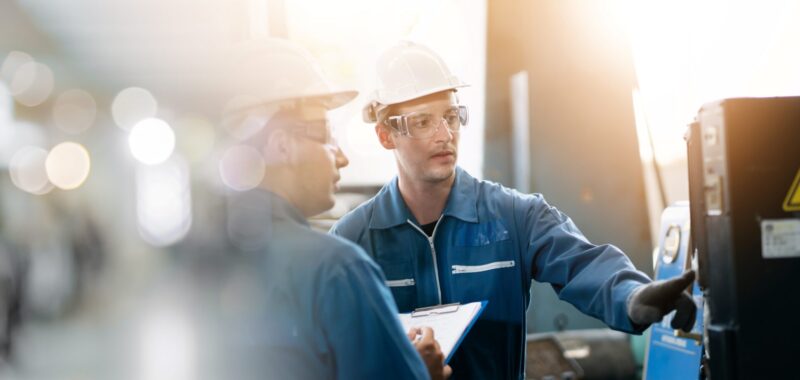Two workers in a factory.