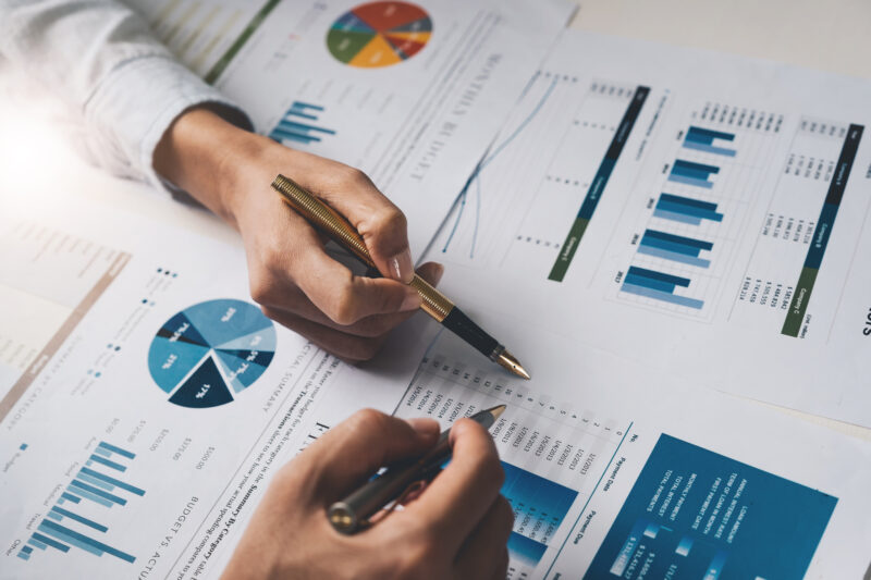 Two people looking at financial documents.