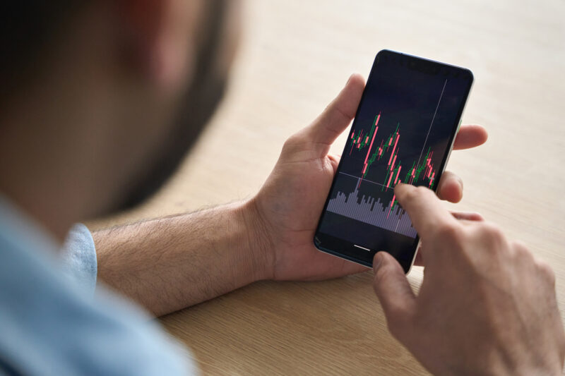 Someone looking at stock market performance on their phone.